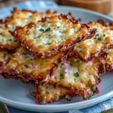 Golden sourdough crackers topped with Parmesan and garlic, baked to crispy perfection for a tangy, cheesy snack.