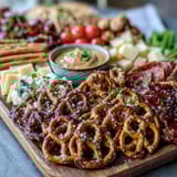 Game Day Baseball Snack Board with Pretzels and Dips, a colorful spread of soft pretzels, creamy dips, and fresh veggies for sharing during the big game.