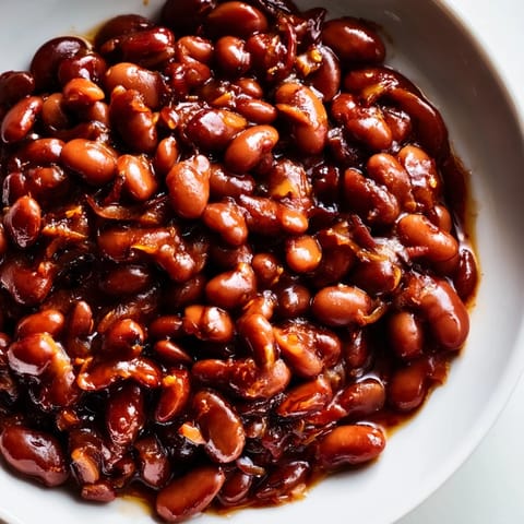 Homemade baked beans, a classic American recipe, with tender beans and a savory tomato flavor.