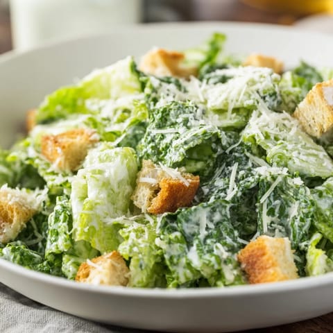 Fresh Caesar salad ingredients, including crunchy croutons and grated Parmesan, look so appetizing.