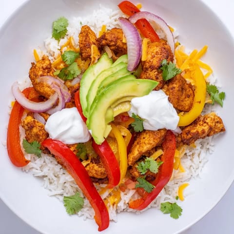 Delicious Chicken Fajita Bowl overflowing with savory chicken, vegetables, and fluffy rice for dinner tonight!