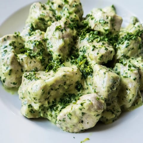 Golden-baked chicken pieces tossed in a vibrant Green Goddess dressing atop fresh salad greens for a protein-packed meal.