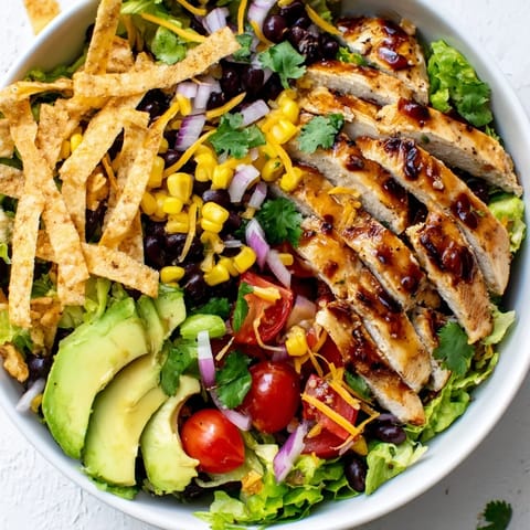 Tortilla strips and diced avocado add creamy, crunchy texture to this honey lime chicken taco salad.