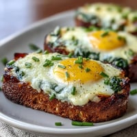 Colorful green eggs and ham baked in muffin cups, a whimsical and savory breakfast perfect for kids and adults alike.